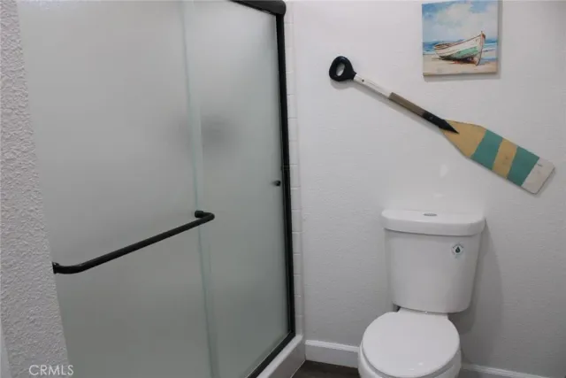 a bathroom with a toilet and a shower