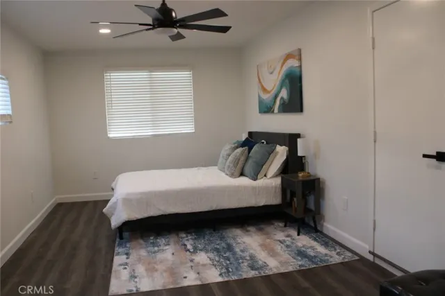 a bed sitting in a bedroom next to a window