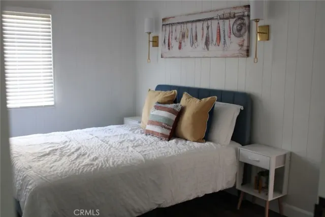a large bed sitting in a bedroom next to a window
