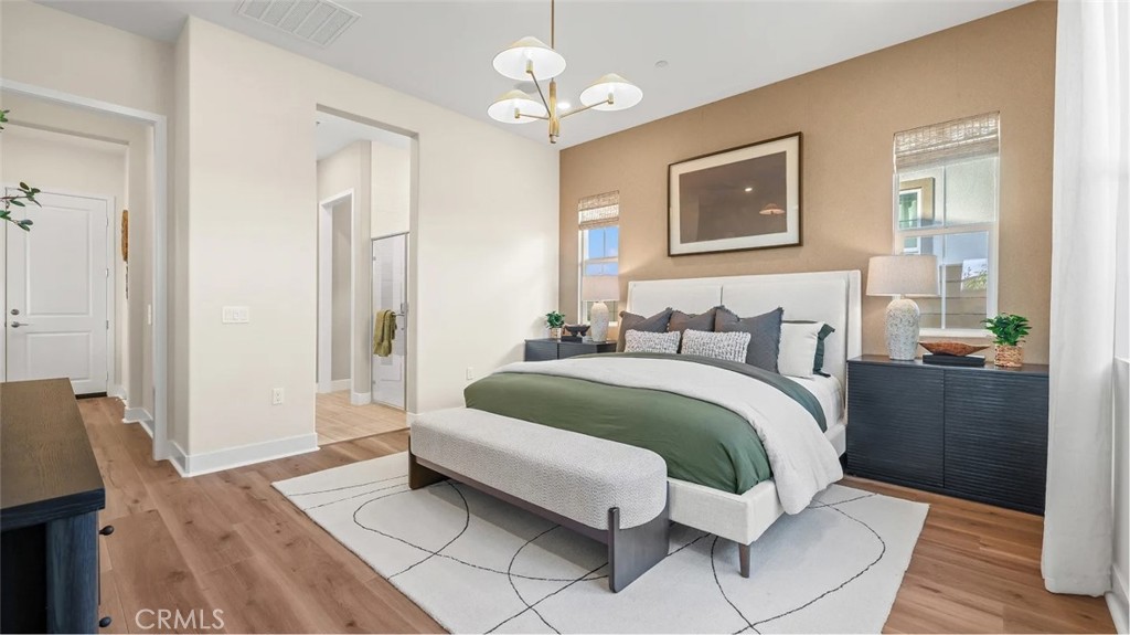1379 Gavilan Ridge Rancho Mission Viejo, CA 92694 - Photo 10 of 27 a spacious bedroom with a bed and a chandelier