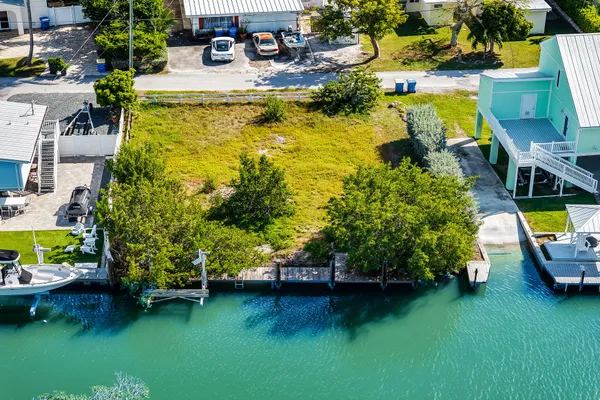 an aerial view of a house with swimming pool patio and outdoor seating