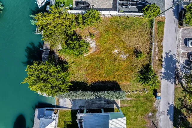 an aerial view of a house with a garden and lake view
