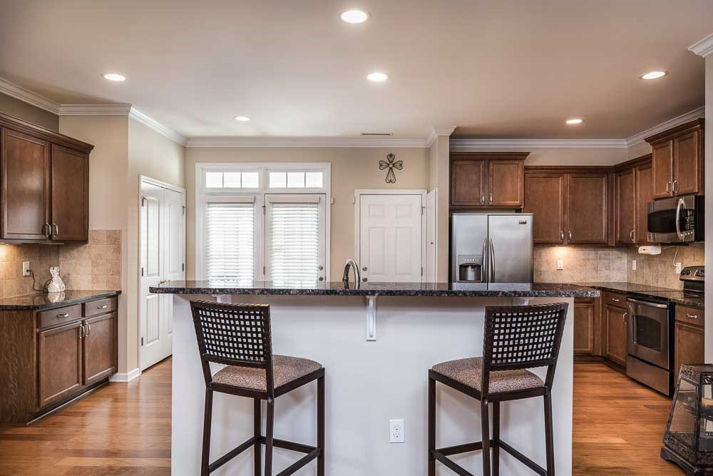 1310 Still Monument Way Raleigh, NC 27603 - Photo 6 of 27 This island and bar will be the central gathering spot for everyone and you'll be able to oversee the room with ease! Hellloooo Amazing Kitchen!