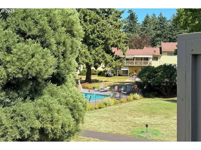 a view of a house with swimming pool and sitting area
