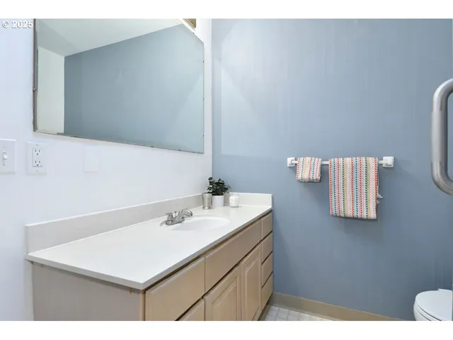 a bathroom with a sink a mirror and a toilet