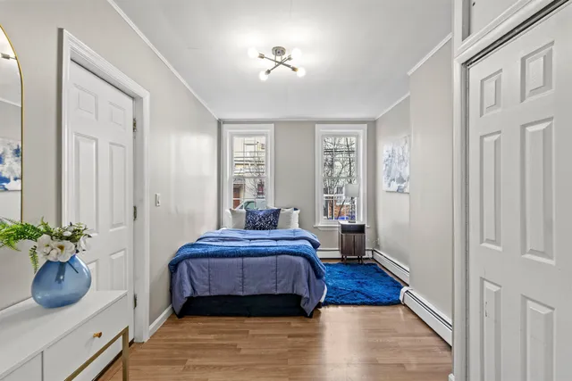 a bedroom with a bed potted plant and a window