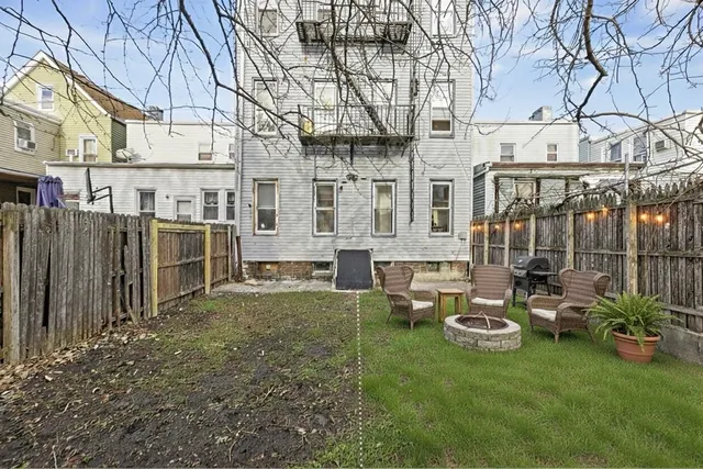 a view of a chairs and tables in the back yard of the house