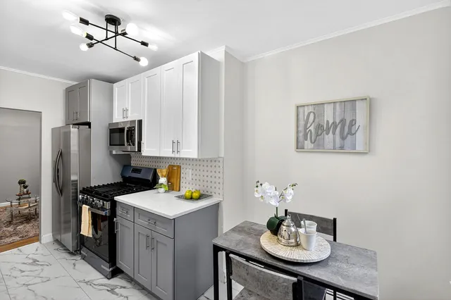 a kitchen with a sink refrigerator and cabinets