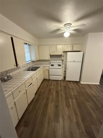 a kitchen with a cabinets and wooden floor