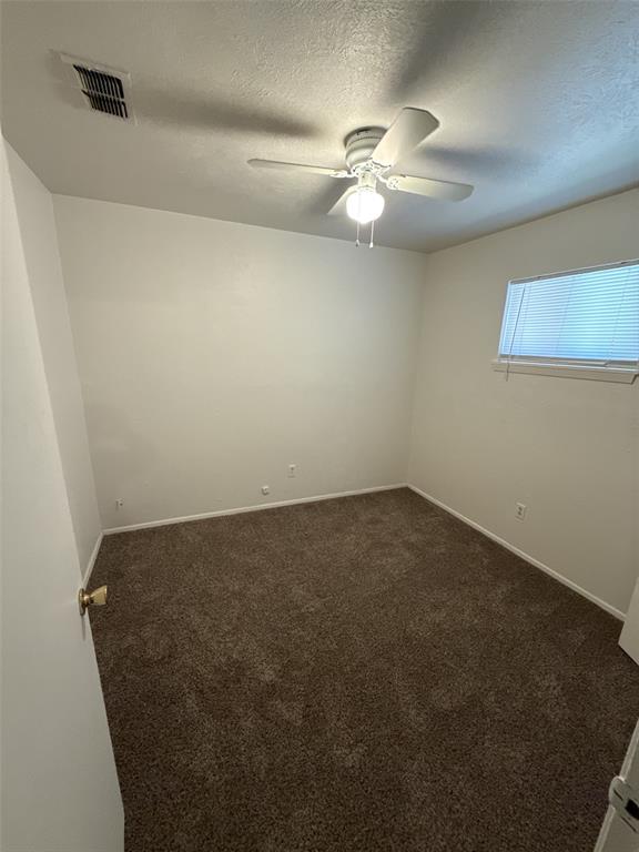 417 Judy Lane Canton, TX 75103 - Photo 8 of 12 an empty room with a chandelier fan and a table