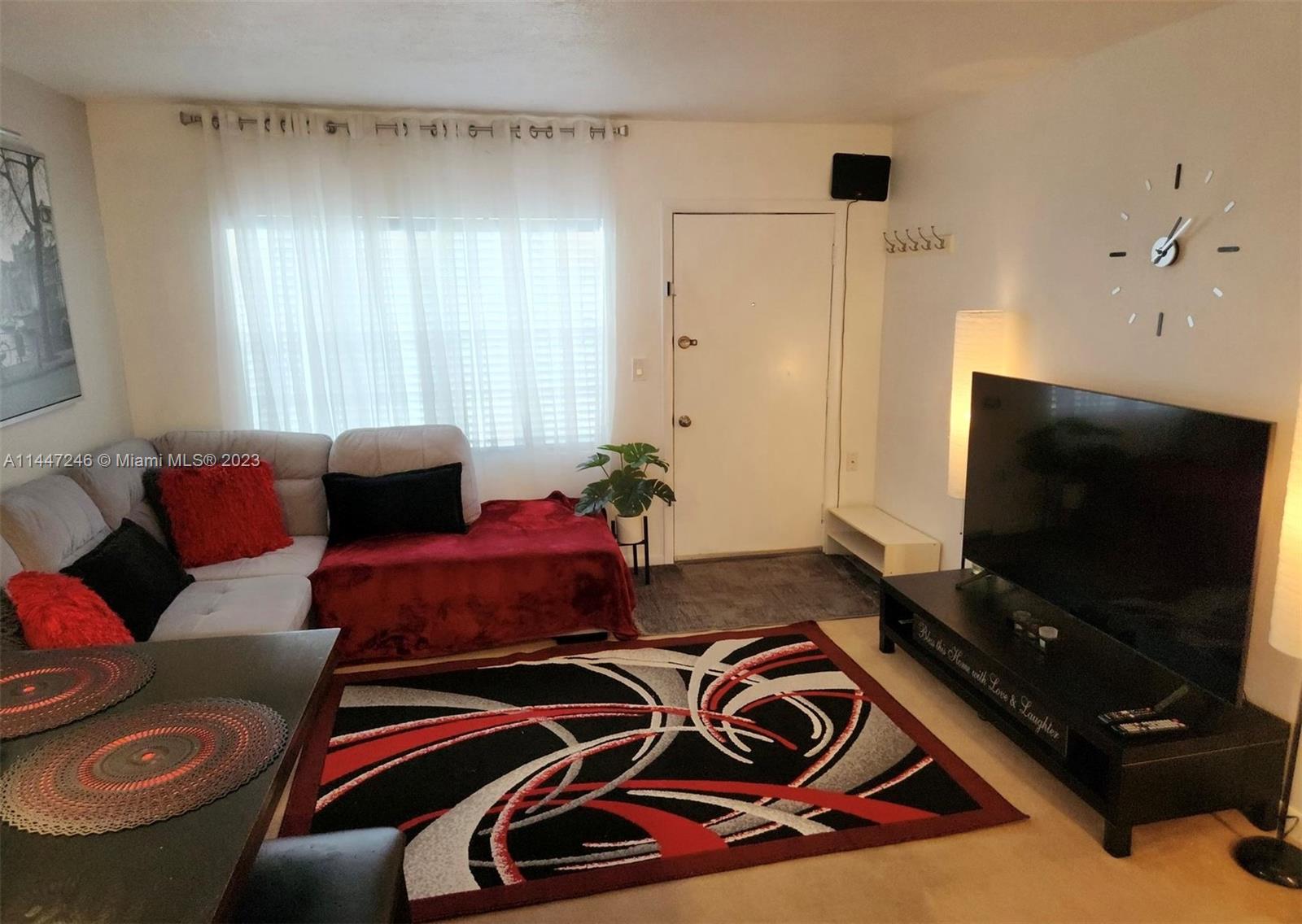 770 Ridenhour Circle, Unit 770 Orlando, FL 32809 - Photo 4 of 10 a living room with furniture and a flat screen tv