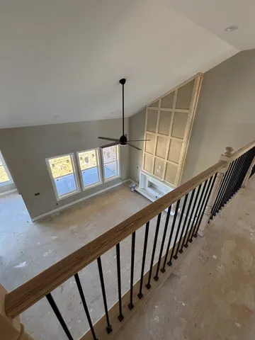 a view of staircase with lots of frames on wall