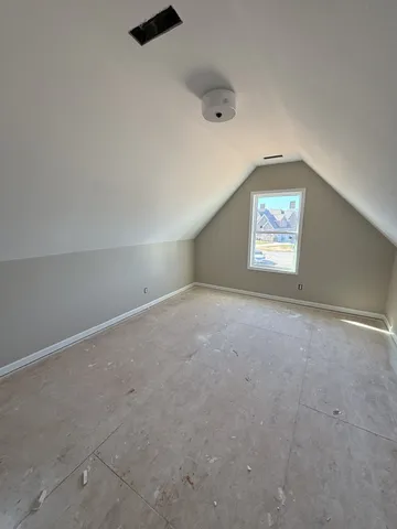 an empty room with a empty space and windows