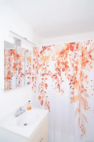 a bathroom with a sink and a shower curtain
