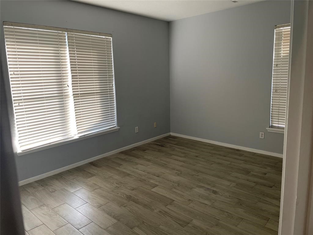 2103 Ragland Drive Houston, TX 77067 - Photo 10 of 18 a view of an empty room with wooden floor and a window
