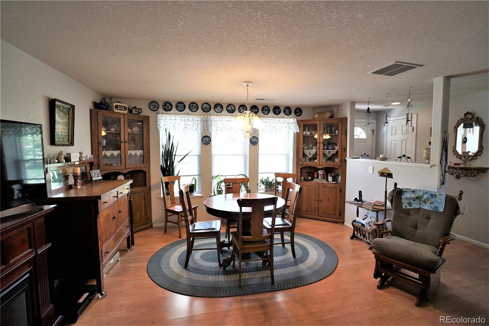 531 Rising Sun Road Bailey, CO 80421 - Photo 3 of 23 a dining room with furniture a rug and a chandelier