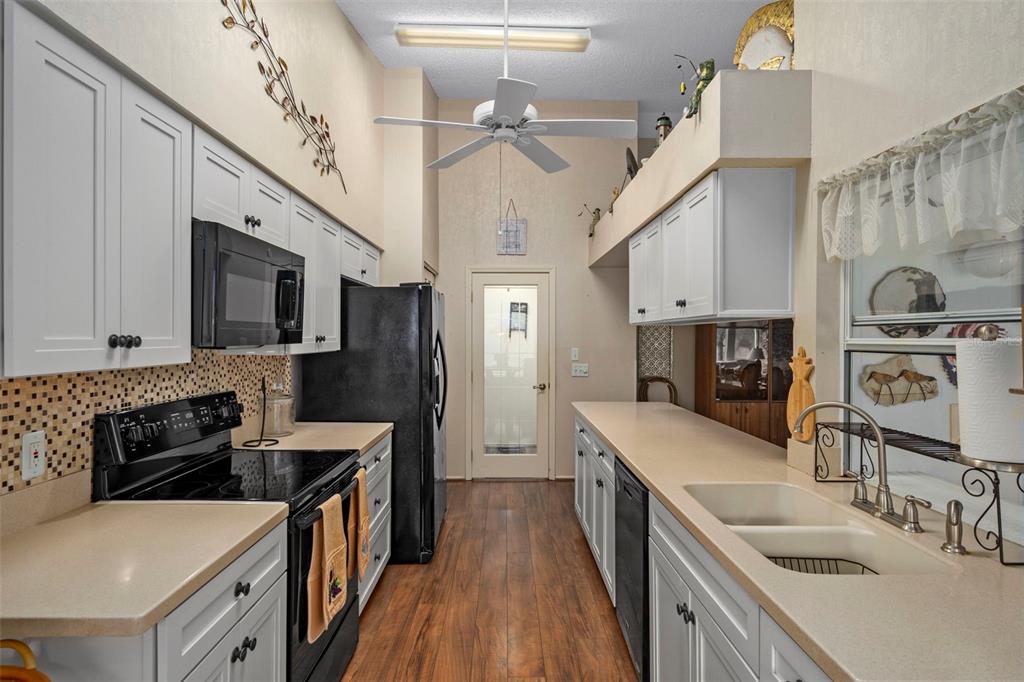 2102 Springmeadow Drive Spring Hill, FL 34606 - Photo 13 of 41 a kitchen with stainless steel appliances granite countertop a sink stove and refrigerator