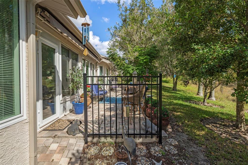 2102 Springmeadow Drive Spring Hill, FL 34606 - Photo 27 of 41 a view of a porch with a floor to ceiling window and garden