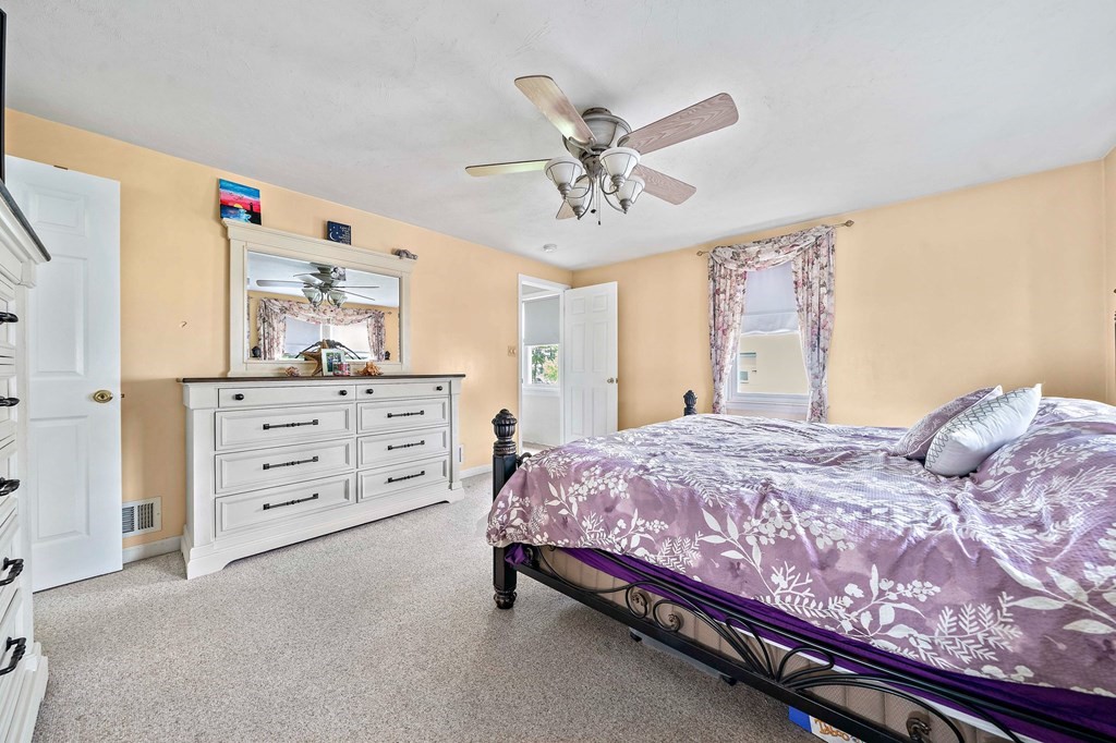 21 Alder Road Holbrook, MA 02343 - Photo 20 of 23 a bedroom with a bed and a chandelier