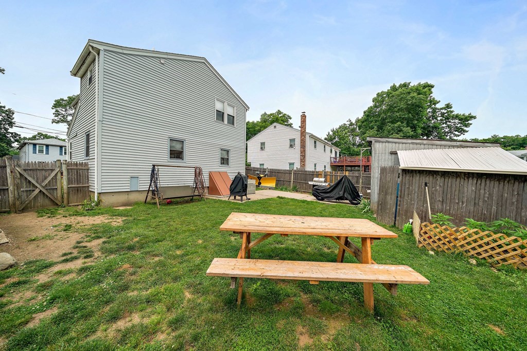 21 Alder Road Holbrook, MA 02343 - Photo 23 of 23 a white bench sitting in the grass near a yard
