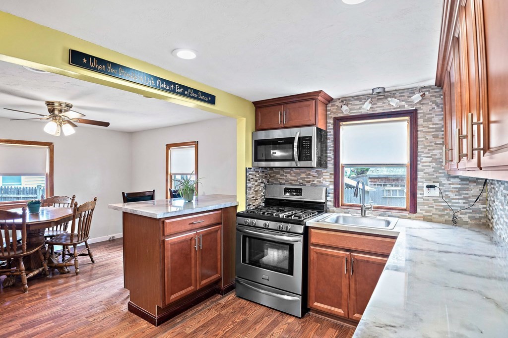 21 Alder Road Holbrook, MA 02343 - Photo 8 of 23 a kitchen with stainless steel appliances granite countertop a stove a sink and a microwave