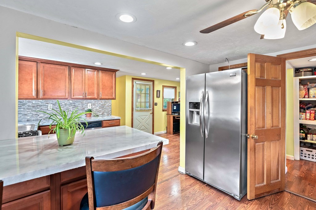 21 Alder Road Holbrook, MA 02343 - Photo 10 of 23 a kitchen with stainless steel appliances granite countertop a refrigerator a stove and a sink with wooden floor