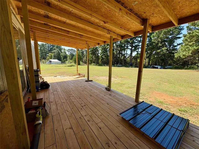a view of a balcony with wooden floor