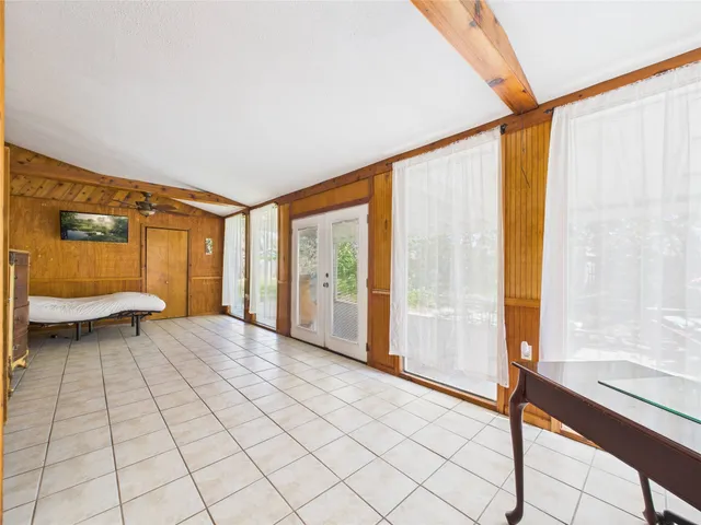 a view of bedroom with furniture and large window