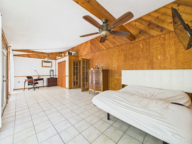 a bedroom with a bed and a night stand