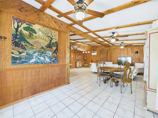 a dining room with furniture and a window