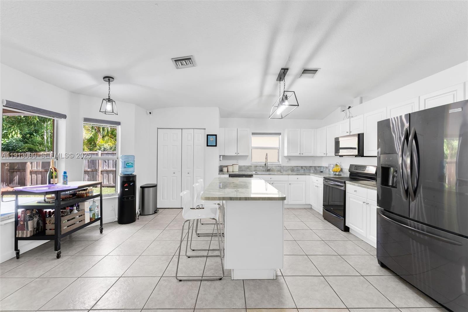 15475 Southwest 138th Terrace Miami, FL 33196 - Photo 11 of 31 a kitchen with cabinets and stainless steel appliances