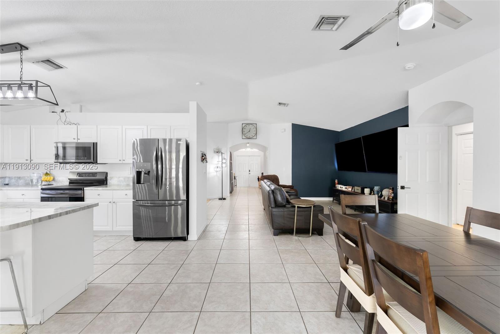 15475 Southwest 138th Terrace Miami, FL 33196 - Photo 13 of 31 a kitchen with stainless steel appliances a refrigerator stove and sink