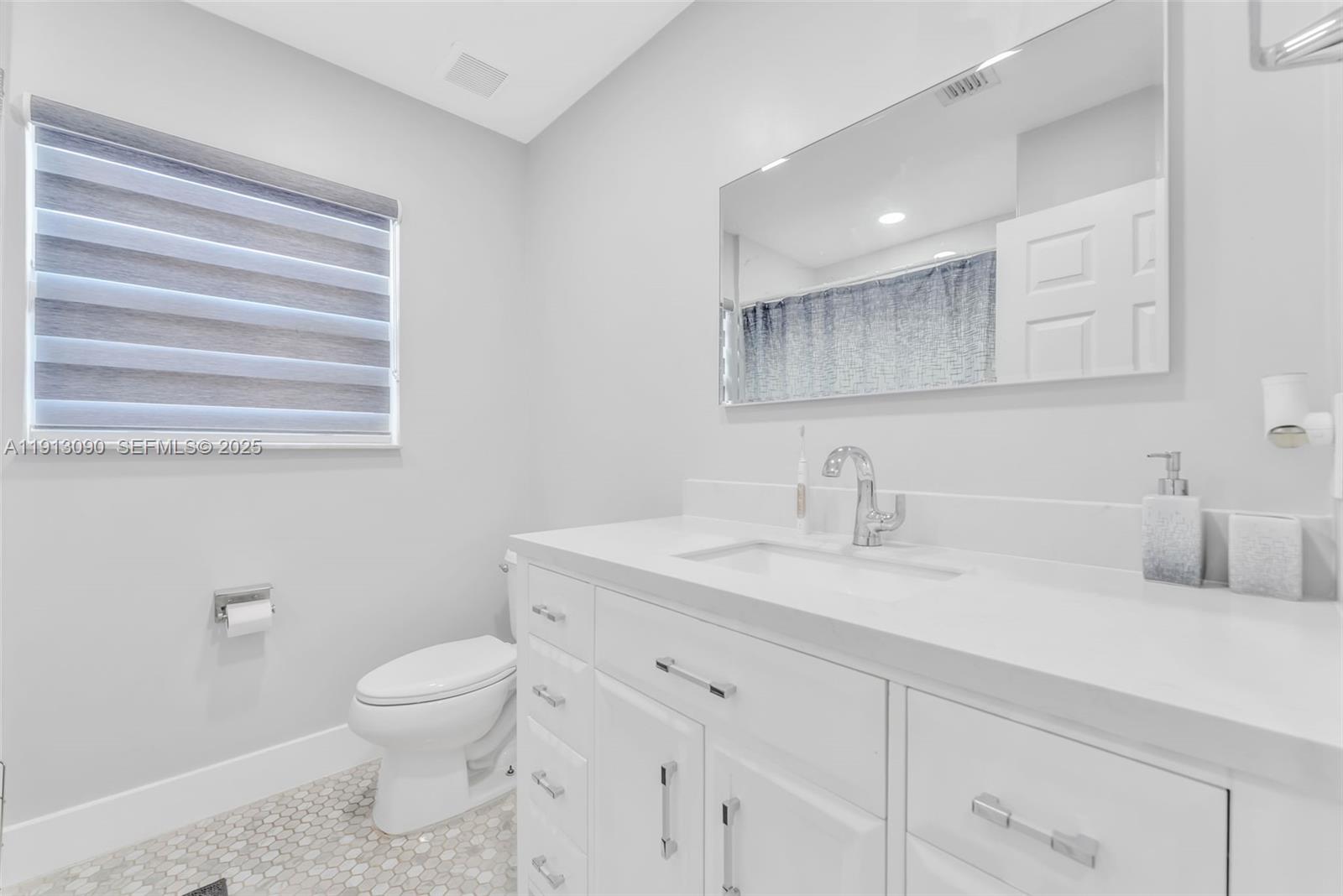 15475 Southwest 138th Terrace Miami, FL 33196 - Photo 15 of 31 a bathroom with a toilet sink and mirror