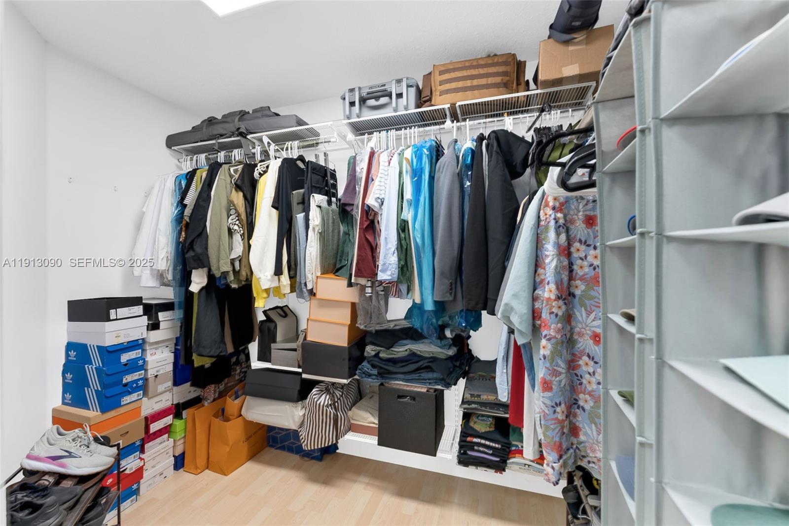 15475 Southwest 138th Terrace Miami, FL 33196 - Photo 20 of 31 a view of walk in closet with clothes and shoes