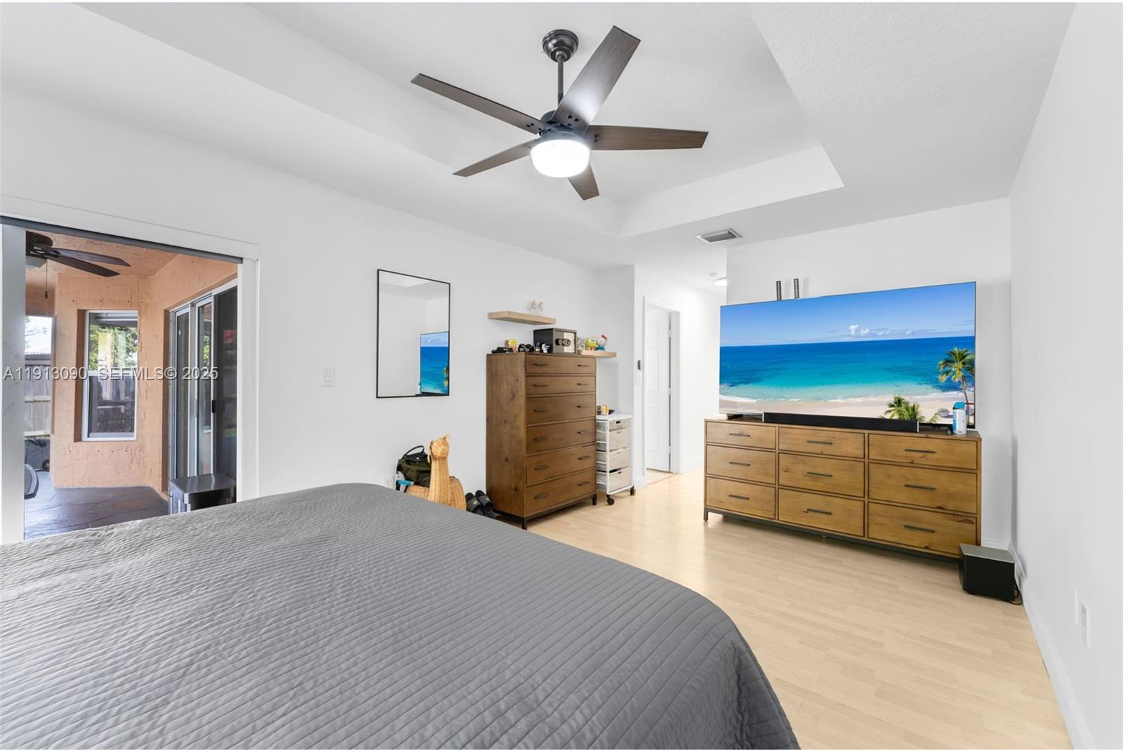 15475 Southwest 138th Terrace Miami, FL 33196 - Photo 22 of 31 a bedroom with a bed and a chandelier