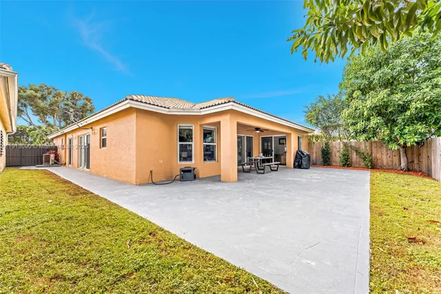 a view of a backyard with sitting area