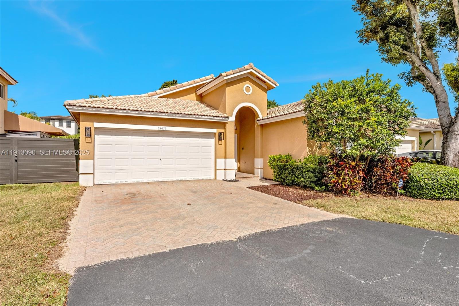 15475 Southwest 138th Terrace Miami, FL 33196 - Photo 3 of 31 a front view of a house with a yard and garage