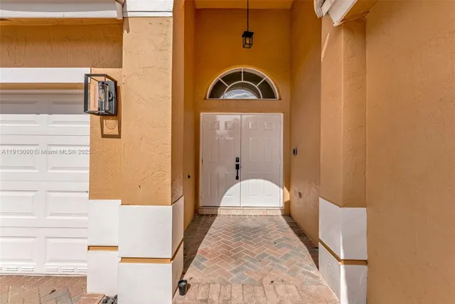 a view of a hallway with a kitchen and dining room