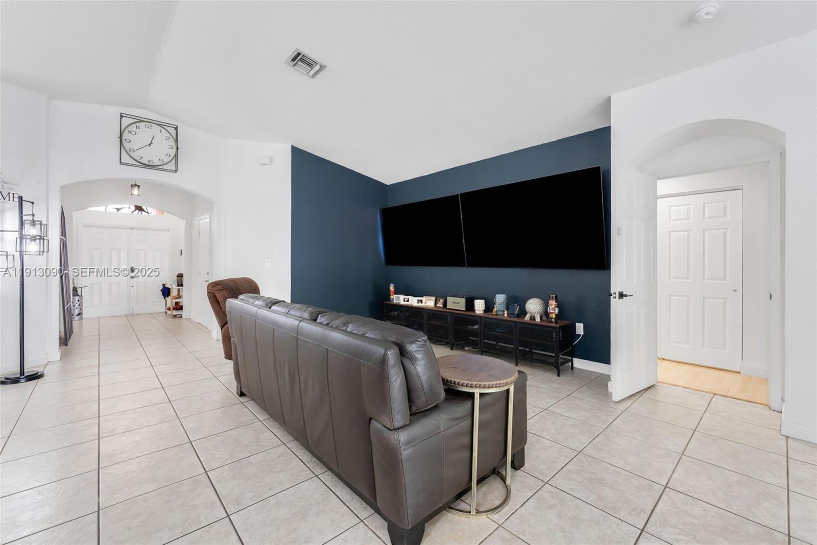 15475 Southwest 138th Terrace Miami, FL 33196 - Photo 6 of 31 a living room with furniture and a flat screen tv