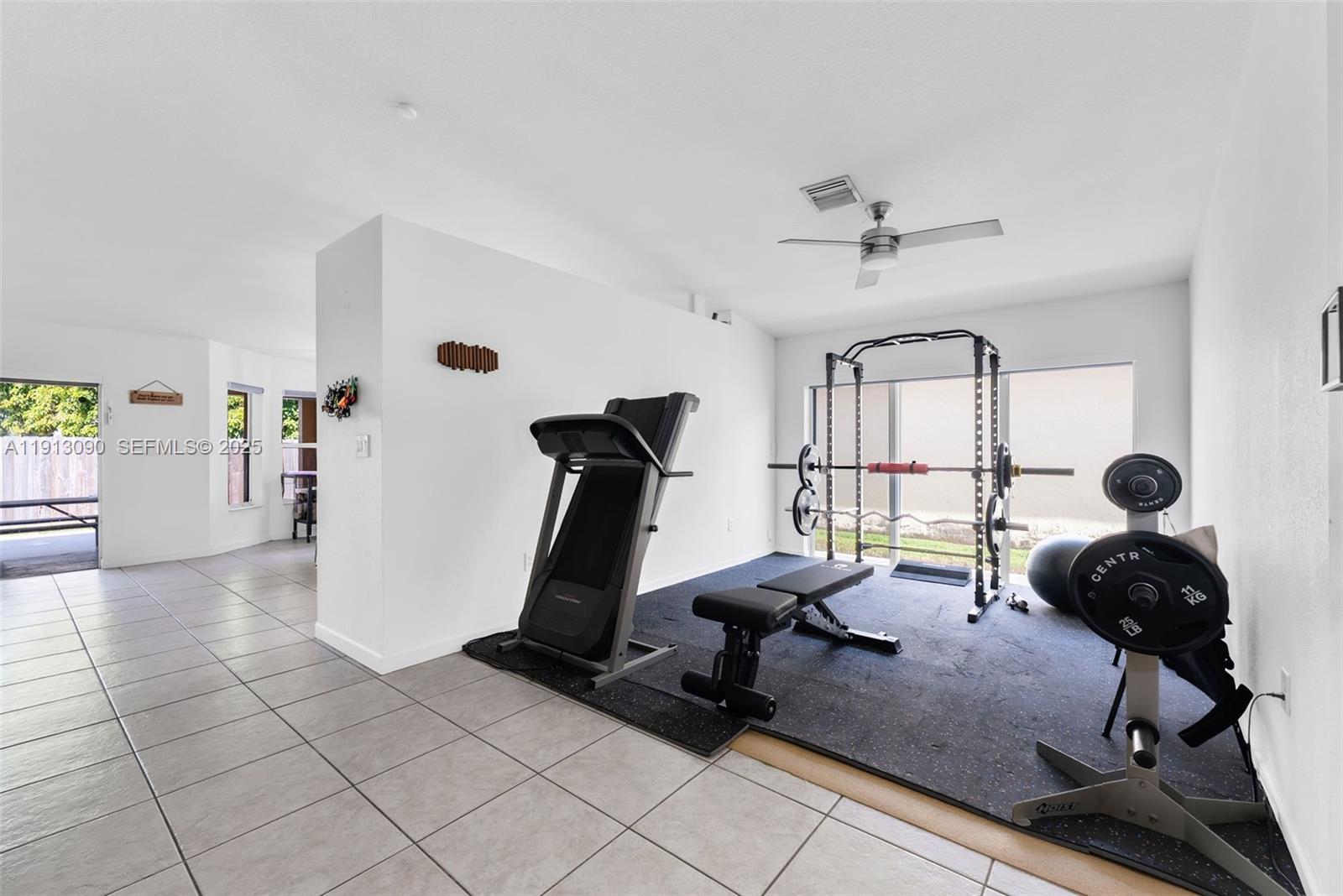 15475 Southwest 138th Terrace Miami, FL 33196 - Photo 7 of 31 a view of a room with gym equipment