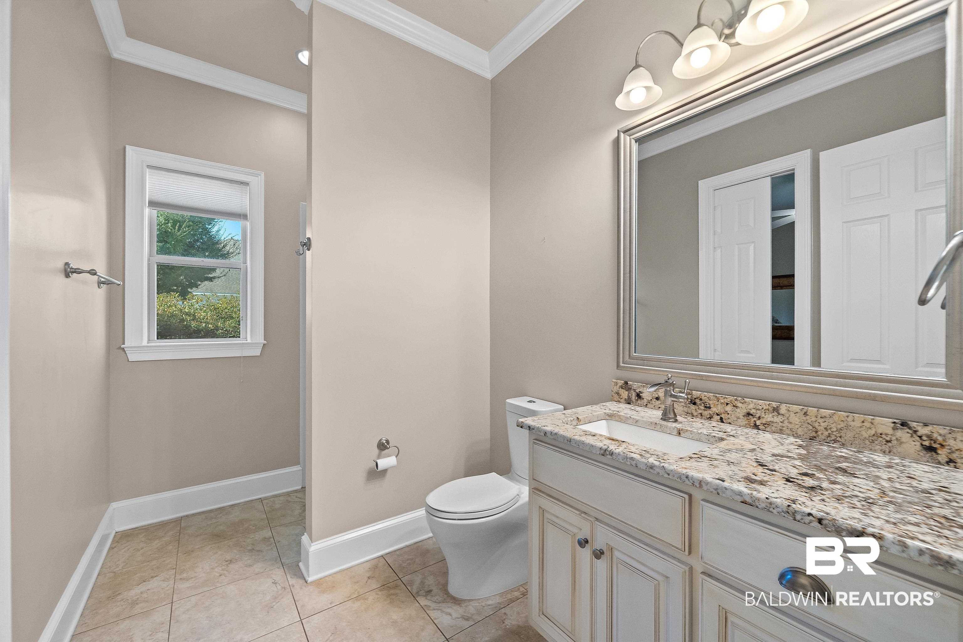 17663 Burwick Loop Fairhope, AL 36532 - Photo 21 of 41 Bathroom featuring ornamental molding, vanity, toilet, and tile patterned floors