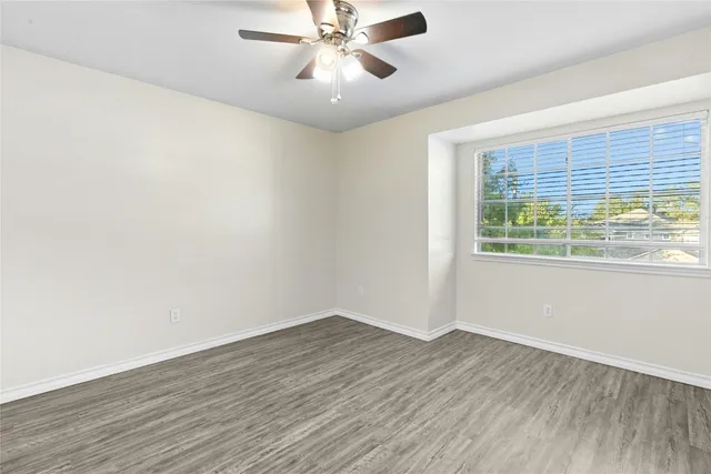wooden floor in an empty room with a window