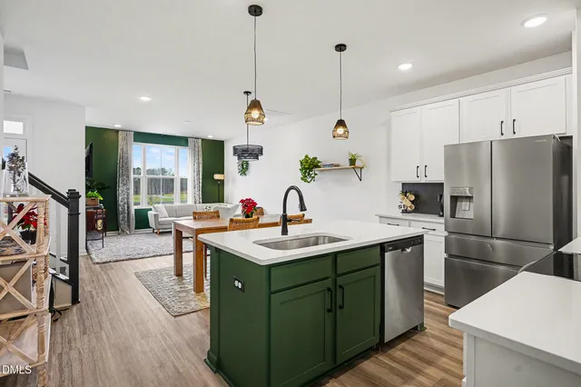 a kitchen with stainless steel appliances granite countertop a sink a stove and a refrigerator