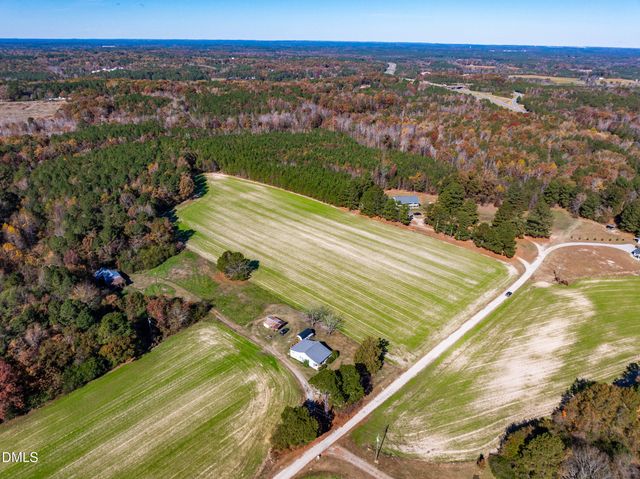 a view of a house with a yard and swimming pool