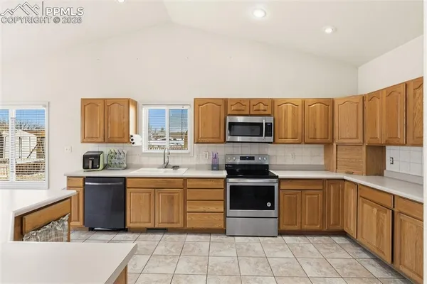 a kitchen with stainless steel appliances a stove sink and cabinets