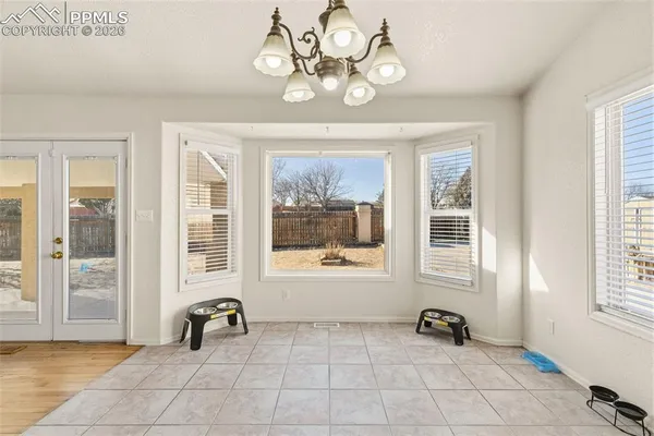 a view of a livingroom with a lounge chair and windows