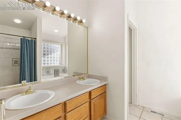 a bathroom with a sink double vanity and a mirror