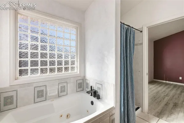 a bathroom with a bathtub and a shower