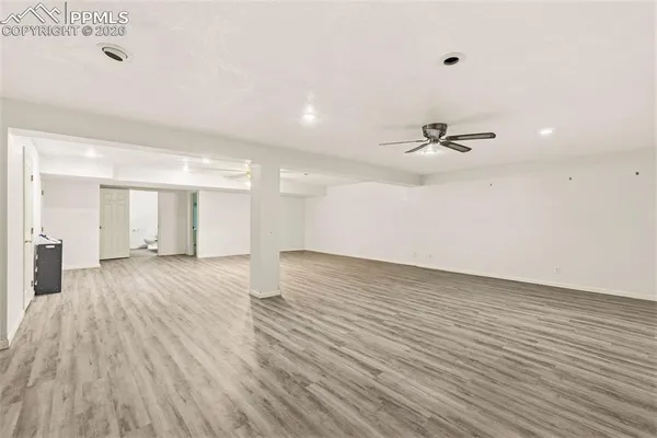 a view of an empty room with wooden floor