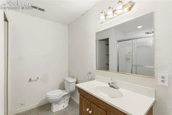 a bathroom with a sink vanity mirror and toilet